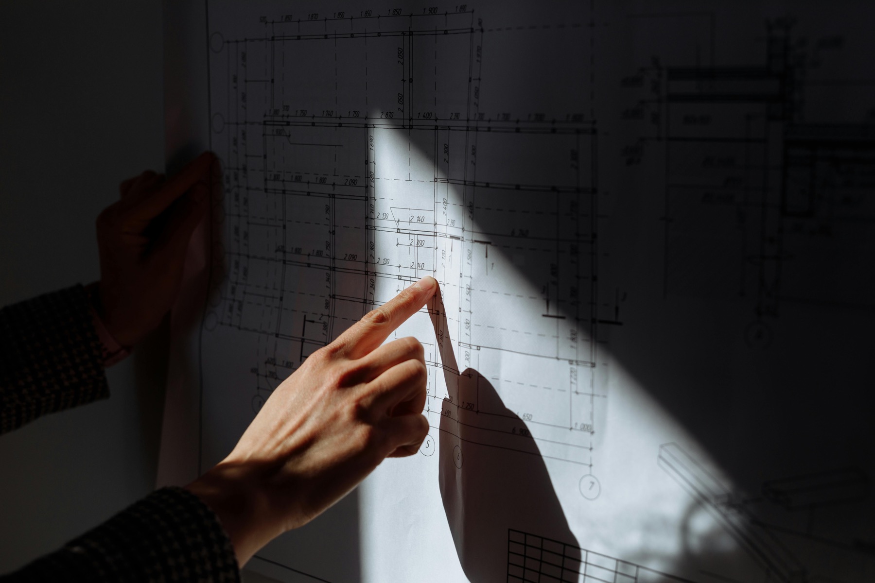 Mano revisando planos técnicos